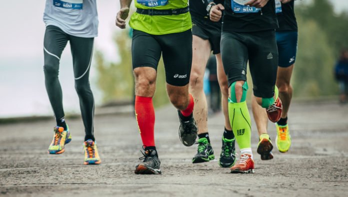 group of athletes running along the embankment